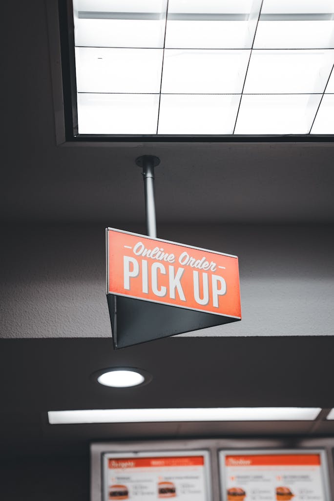 Close-up of an online order pick up sign in a fast-food restaurant indicating service area.