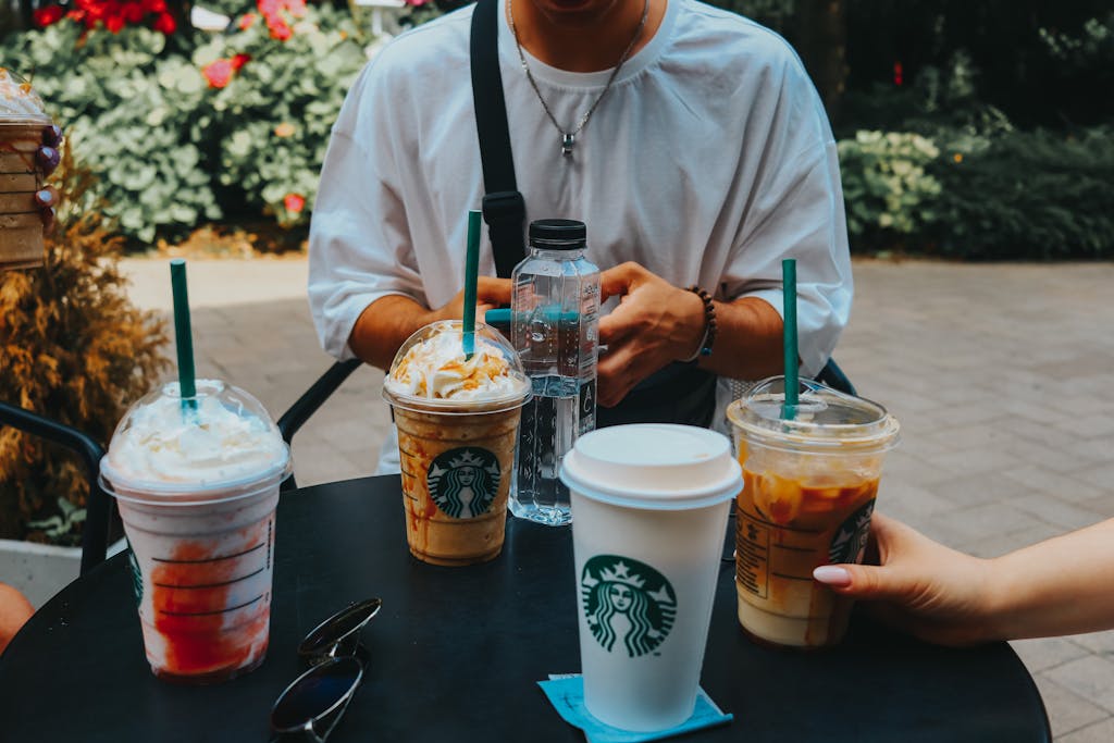 A group enjoying Starbucks coffee outdoors, capturing casual social moments.